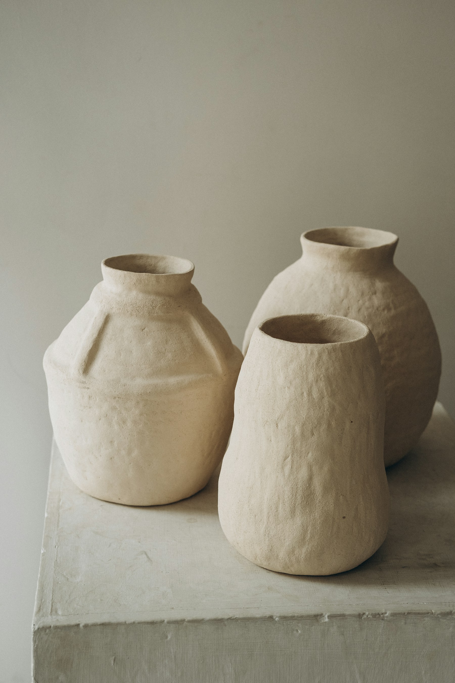 Three pale stoneware jars grouped together